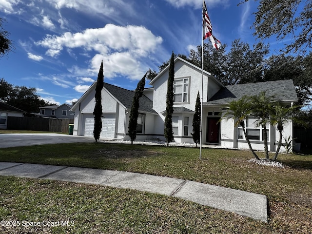 view of front of house with a garage and a front yard