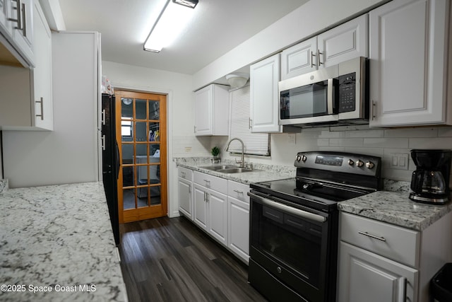 kitchen featuring white cabinetry, black range with electric stovetop, sink, and backsplash