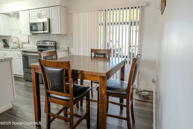 dining room with hardwood / wood-style flooring and sink