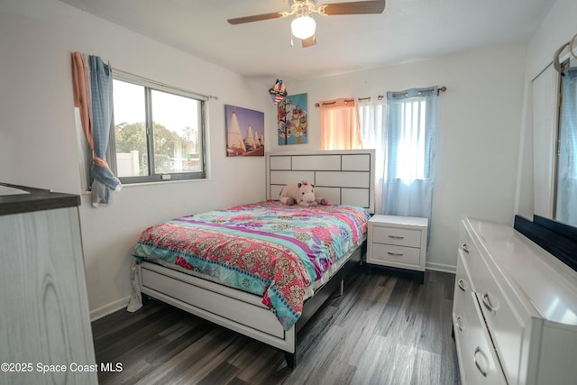 bedroom with multiple windows, ceiling fan, and dark hardwood / wood-style flooring