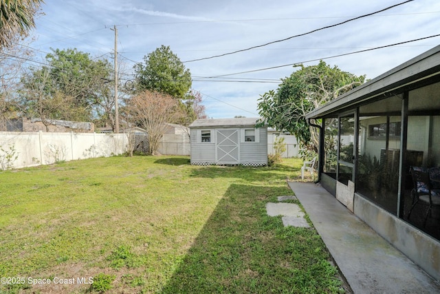 view of yard with a sunroom and a storage unit