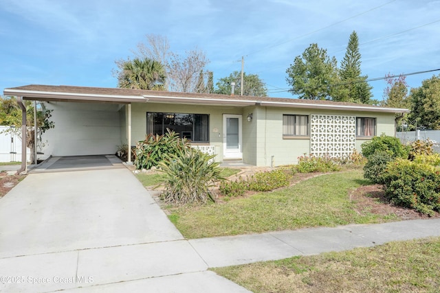 ranch-style home featuring a carport and a front yard