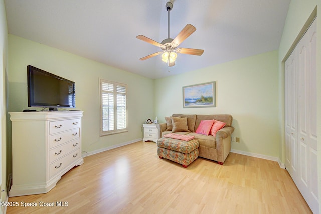 sitting room with light hardwood / wood-style flooring and ceiling fan