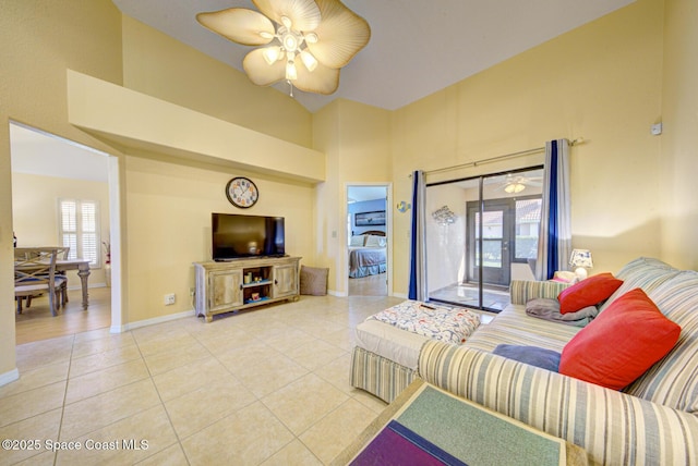 living room with light tile patterned floors, a wealth of natural light, high vaulted ceiling, and ceiling fan