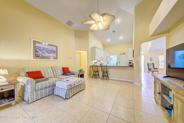 living room featuring light tile patterned floors, high vaulted ceiling, sink, and ceiling fan