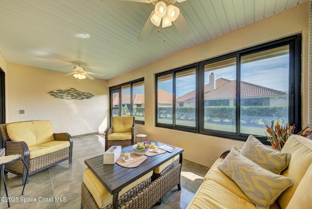 living room featuring tile patterned flooring and ceiling fan