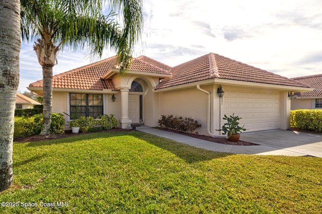 mediterranean / spanish-style home featuring a garage and a front yard