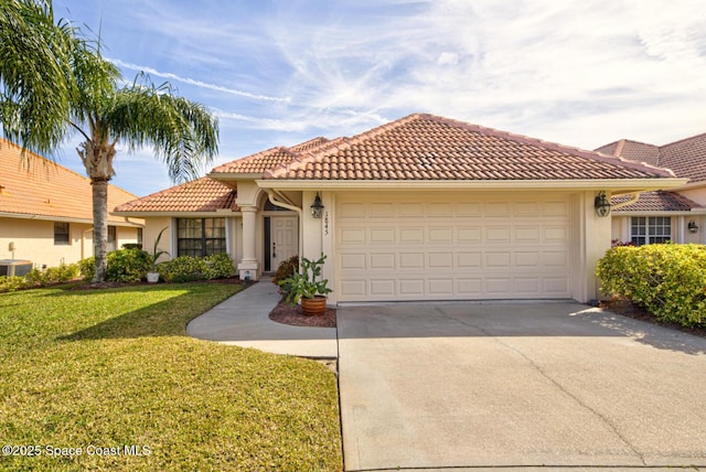 mediterranean / spanish-style home featuring cooling unit, a garage, and a front yard