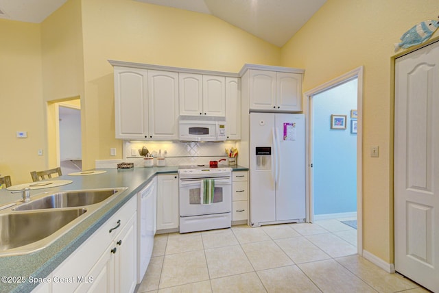 kitchen with sink, white appliances, light tile patterned floors, white cabinetry, and decorative backsplash