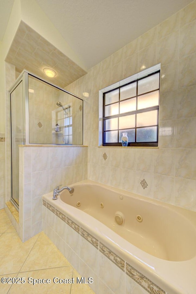 bathroom with independent shower and bath, tile walls, and tile patterned floors