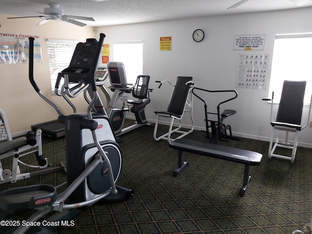 workout area with ceiling fan and a textured ceiling