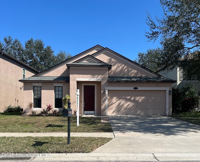 view of front of home featuring a garage and a front lawn