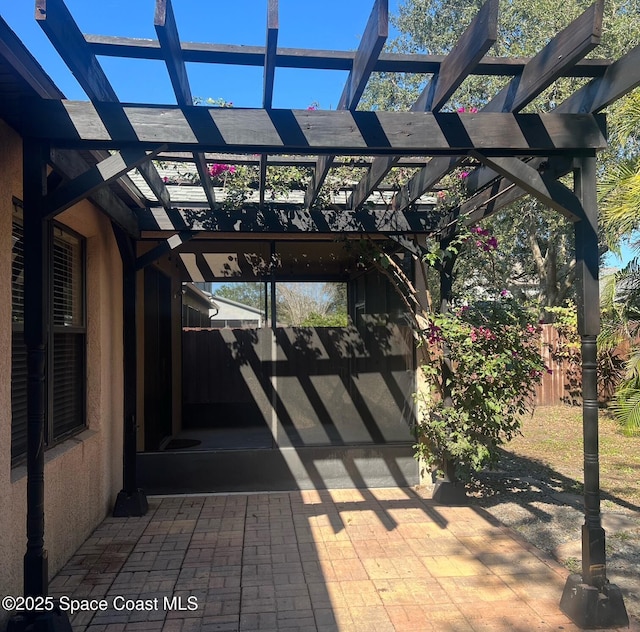 view of patio featuring fence and a pergola