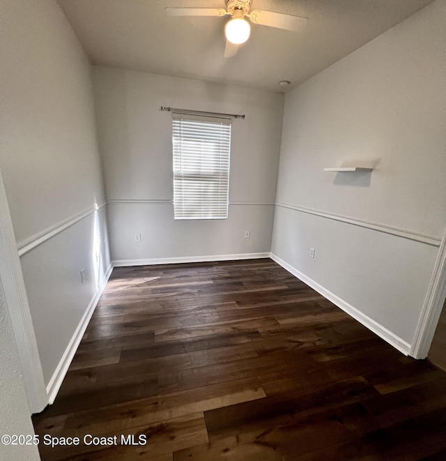 unfurnished room featuring a ceiling fan, wood finished floors, and baseboards