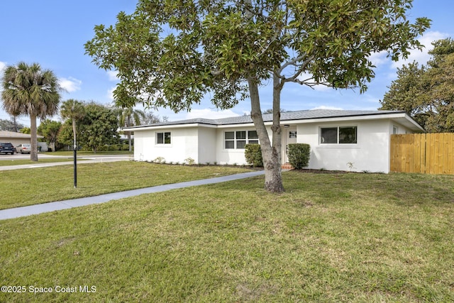 ranch-style home with a front lawn