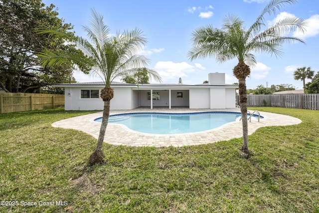 view of pool with a lawn and a patio area