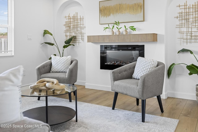 sitting room with wood-type flooring