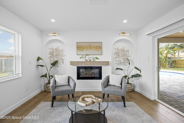 living area with hardwood / wood-style flooring