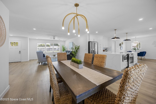 dining room featuring ceiling fan and light wood-type flooring