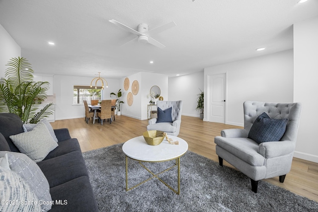 living room with hardwood / wood-style floors and ceiling fan