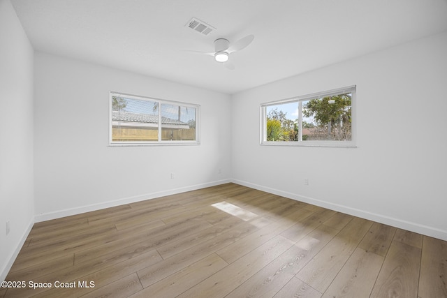 spare room with ceiling fan and light wood-type flooring