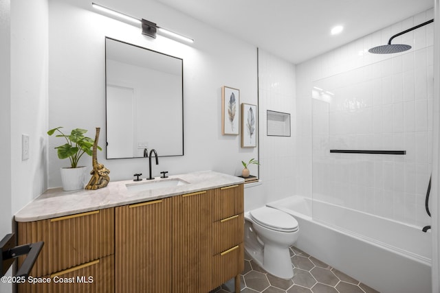 full bathroom featuring tile patterned floors, vanity, toilet, and tiled shower / bath combo