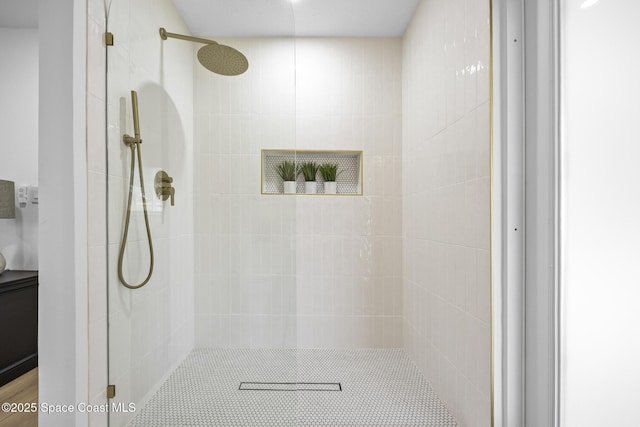 bathroom with a tile shower