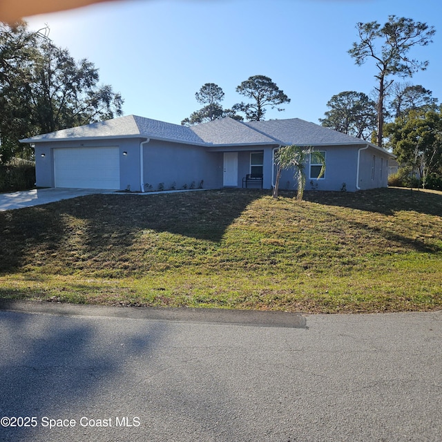 view of front of home featuring a garage and a front lawn