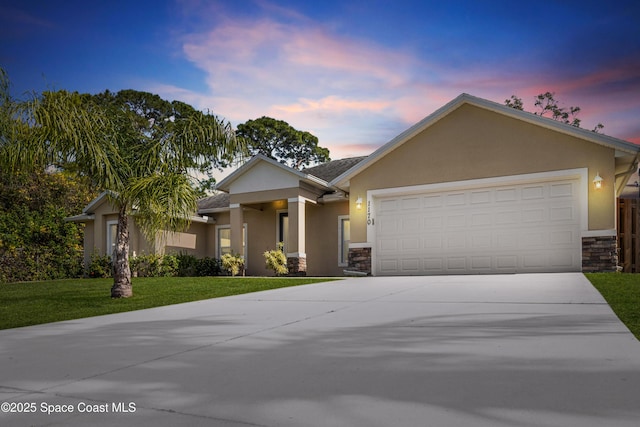 view of front facade featuring a garage and a yard