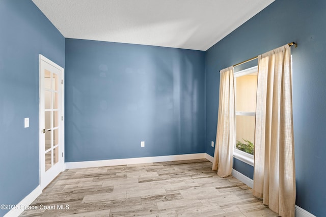 unfurnished room with light hardwood / wood-style floors