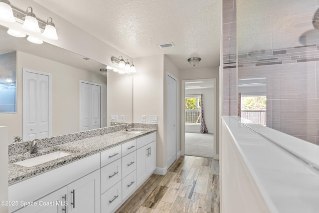 bathroom with vanity and a textured ceiling