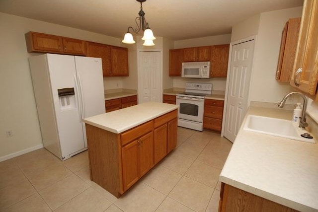 kitchen featuring sink, a center island, light tile patterned floors, pendant lighting, and white appliances