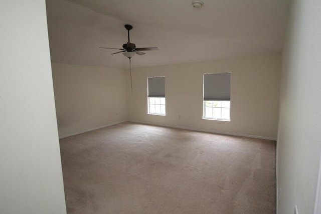 unfurnished room featuring light colored carpet and ceiling fan