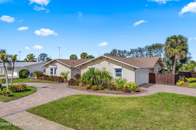 single story home with a garage and a front yard