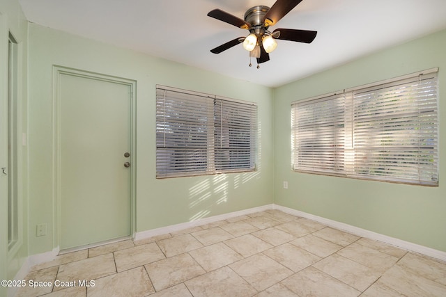 tiled empty room with ceiling fan