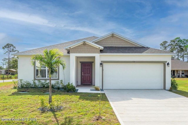 view of front of property featuring a garage and a front yard