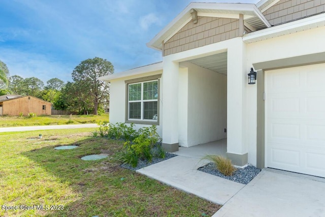 doorway to property featuring a lawn