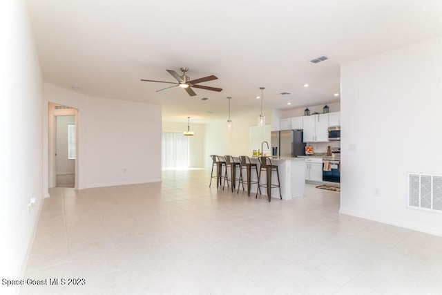 living room with sink and ceiling fan