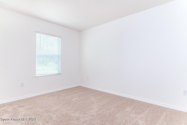 empty room featuring light colored carpet