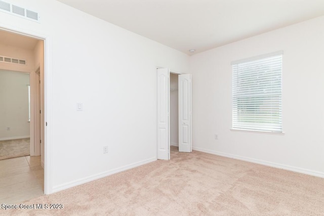 unfurnished room with light carpet