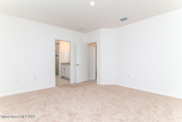 unfurnished room with light colored carpet