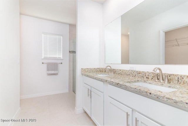 bathroom with vanity and a shower