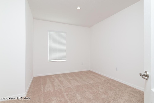 empty room with light colored carpet