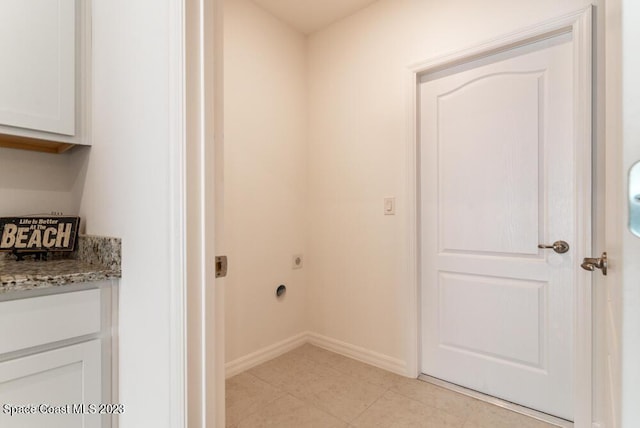 clothes washing area with cabinets and electric dryer hookup