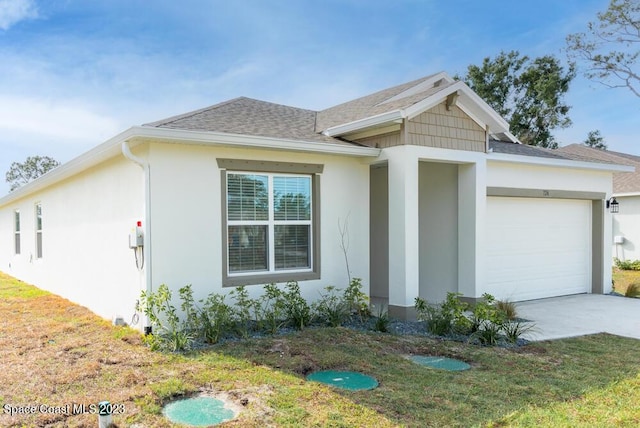 view of front of home with a garage and a front lawn