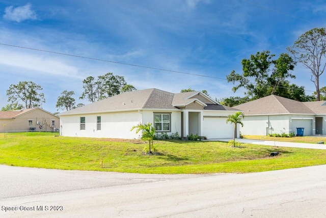 single story home with a garage and a front lawn