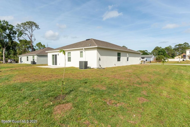 back of house with a yard, central AC unit, and a patio