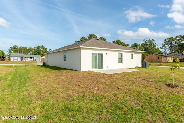 back of property with a patio, a yard, and central air condition unit