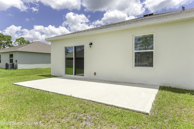 724 San Filippo Dr SE, Palm Bay, FL 32909 - back of house featuring a patio, cooling unit, stucco siding, and a lawn