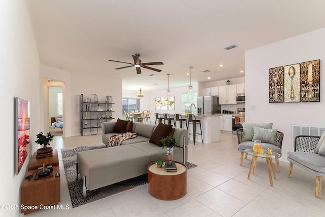 724 San Filippo Dr SE, Palm Bay, FL 32909 - living room with a ceiling fan, light tile patterned floors, and recessed lighting